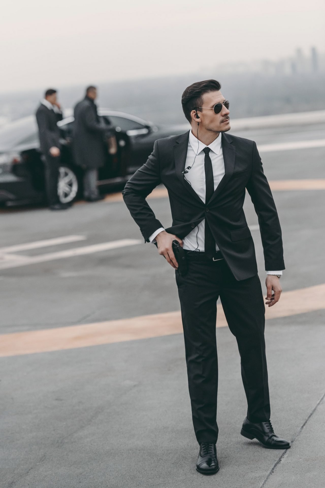 handsome bodyguard with security earpiece and gun.jpg